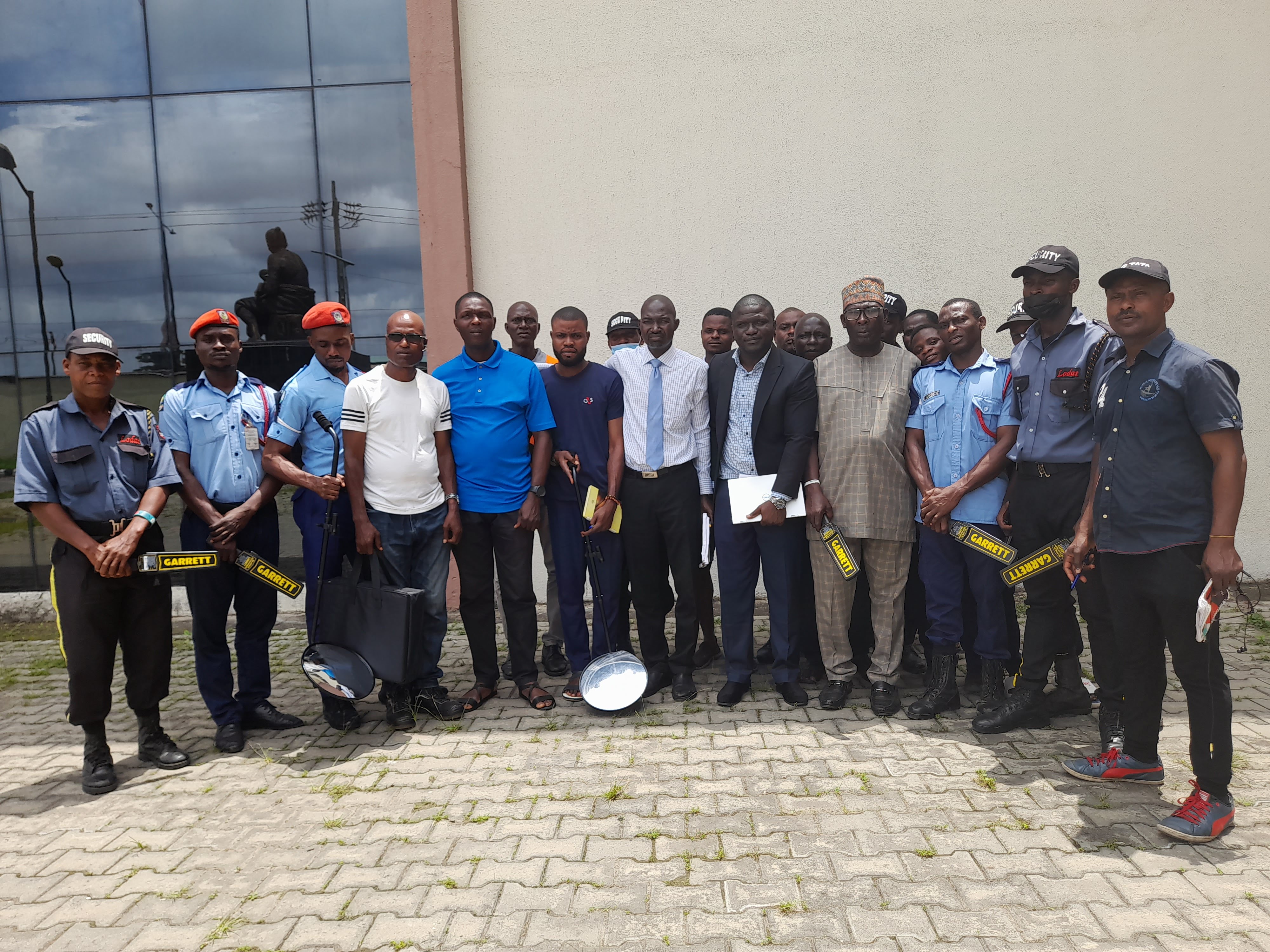 Protego corporate security team and officials at training completion ceremony with security equipment in Nigeria